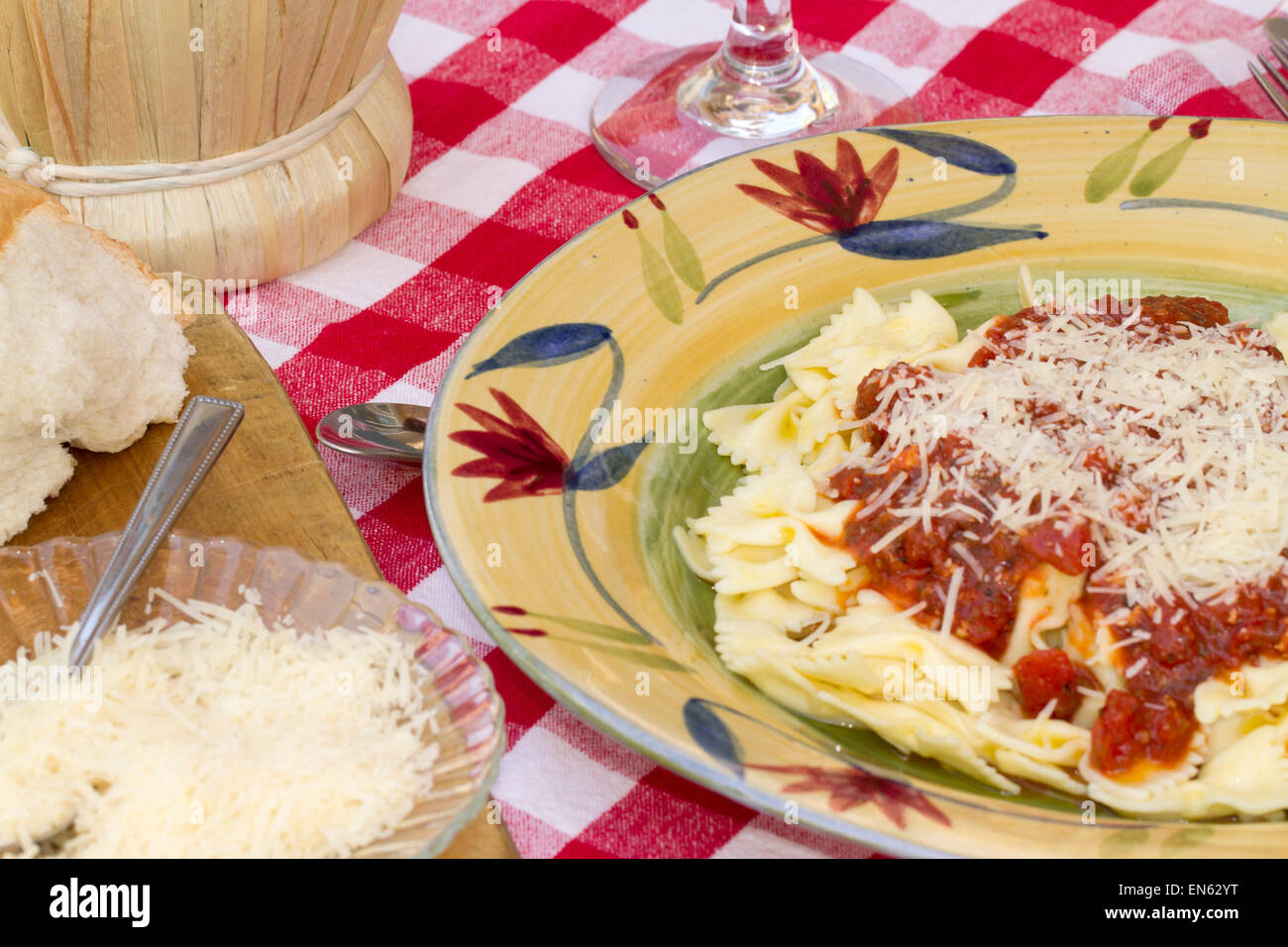 Italian pasta dinner served with Marinara sauce, parmesan cheese, over