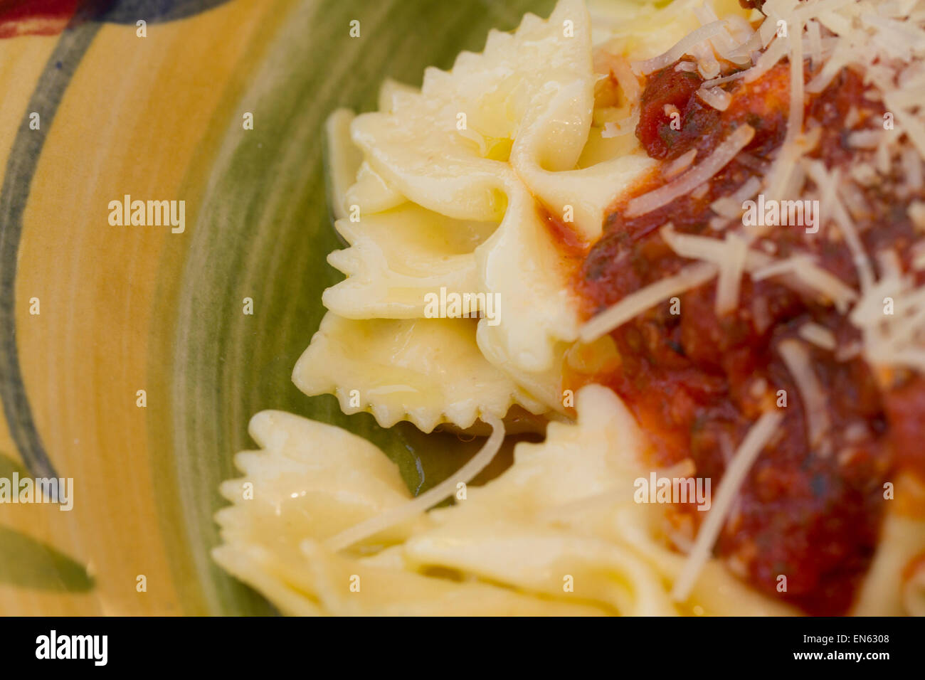 Italian pasta dinner served with Marinara sauce, parmesan cheese, over