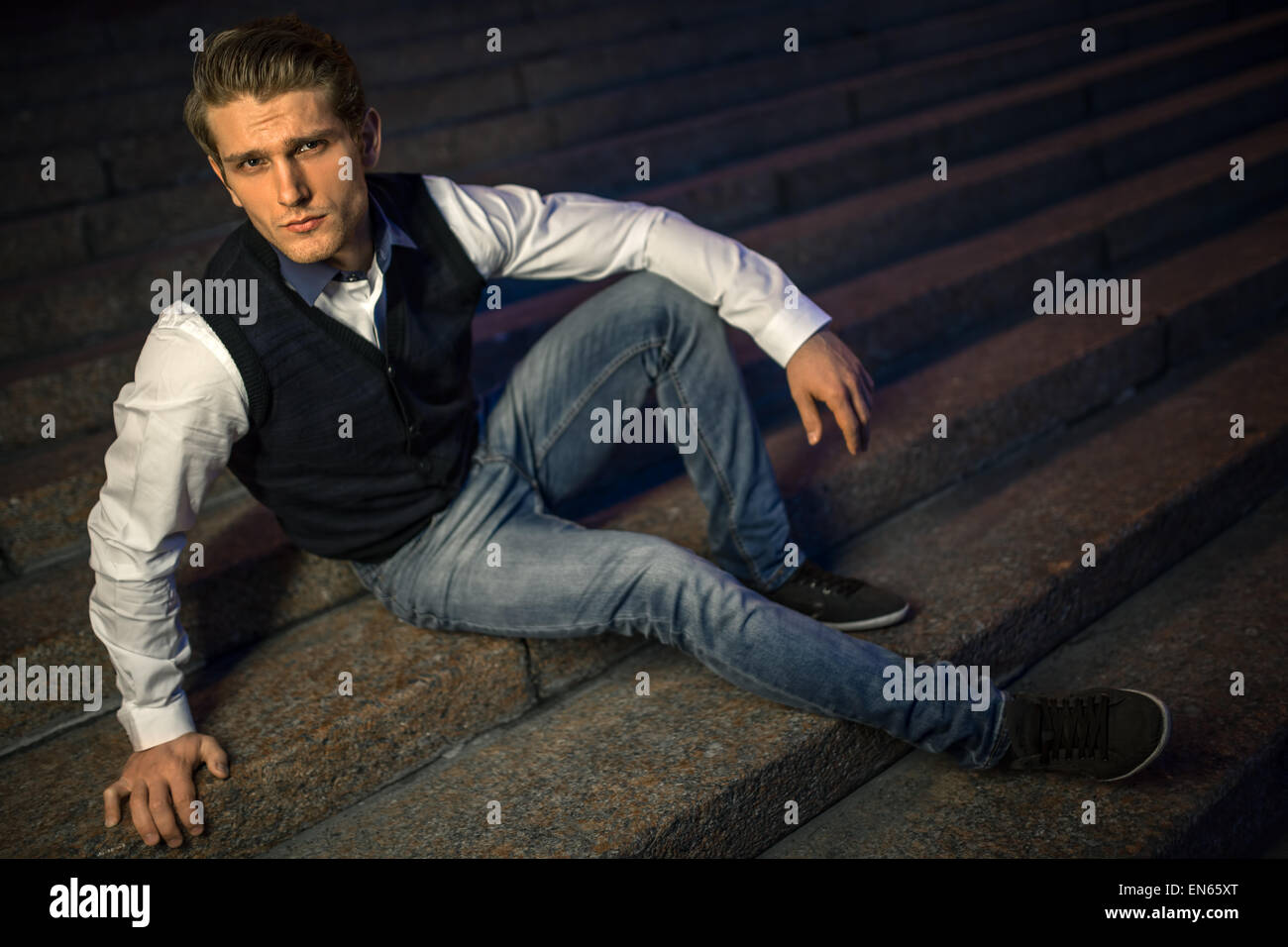 Handsome guy sitting on stairs Stock Photo - Alamy