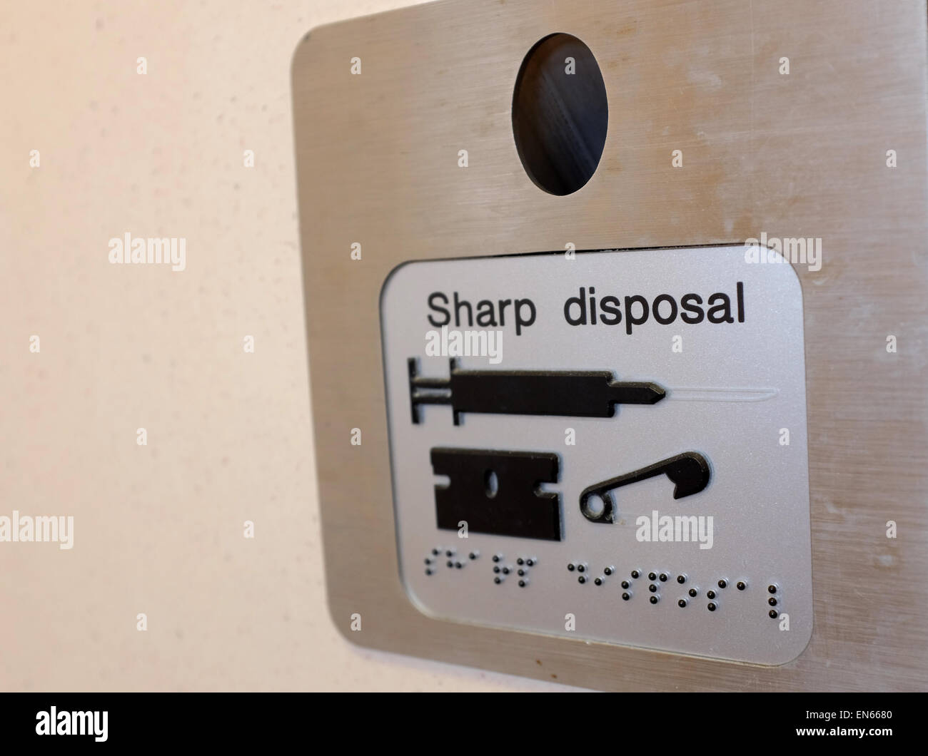 Sharp disposal needle bin in a public toilet England UK Stock Photo