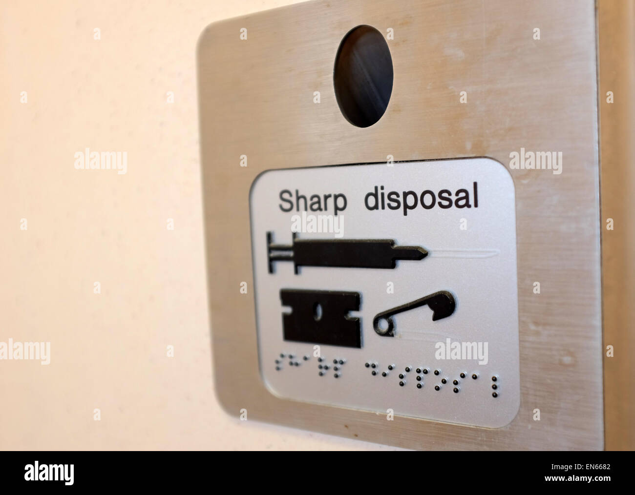 Sharp disposal needle bin in a public toilet England UK Stock Photo