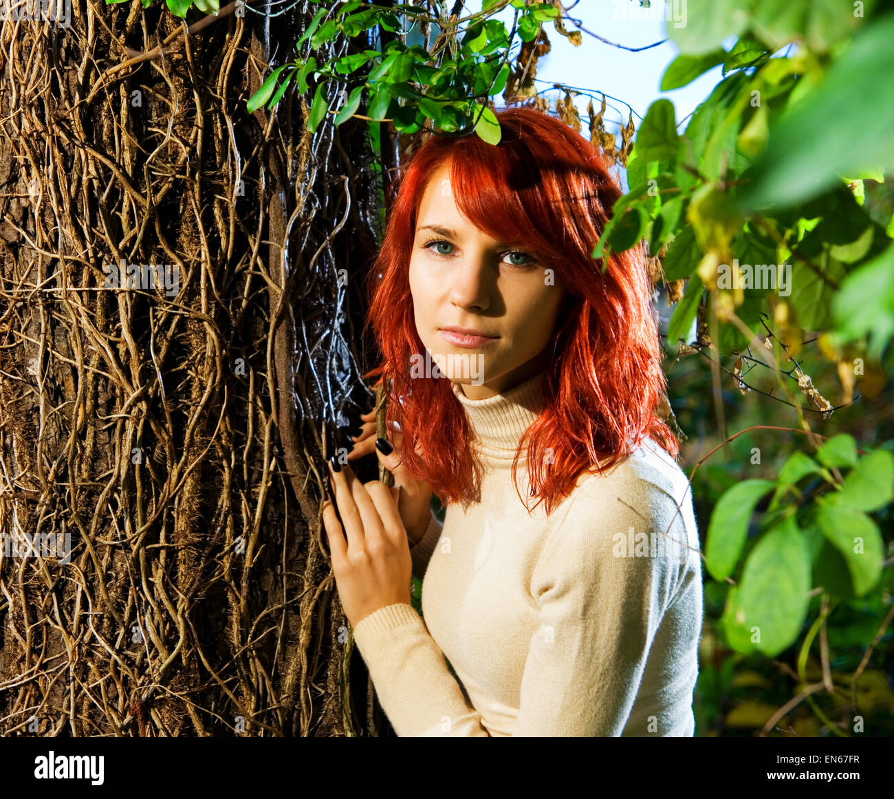 Beautiful redhead girl in the forest Stock Photo - Alamy
