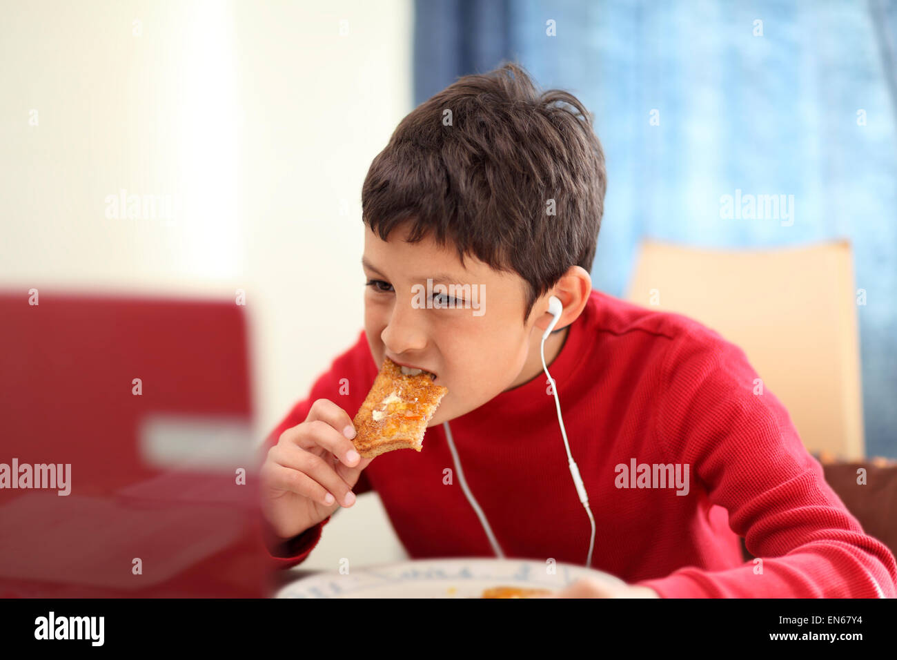 Young boy eating breakfast toast - shallow depth of field Stock Photo