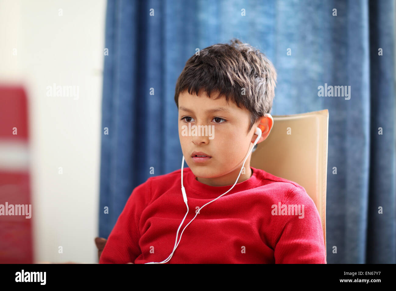 Young boy looks blankly at computer - shallow depth of field Stock Photo