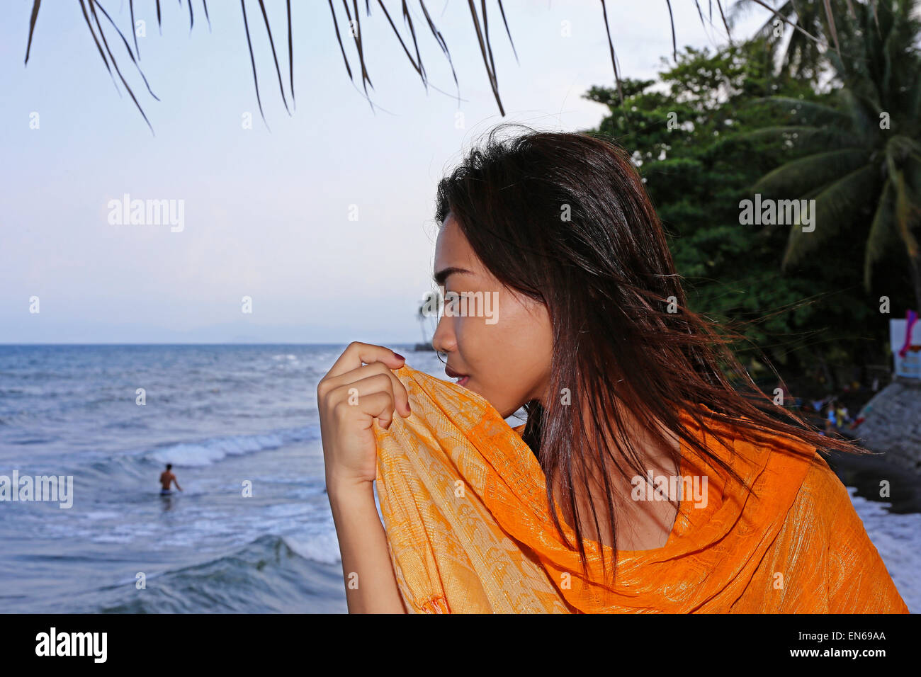 Young woman looking out over the sea in the Philippines Stock Photo
