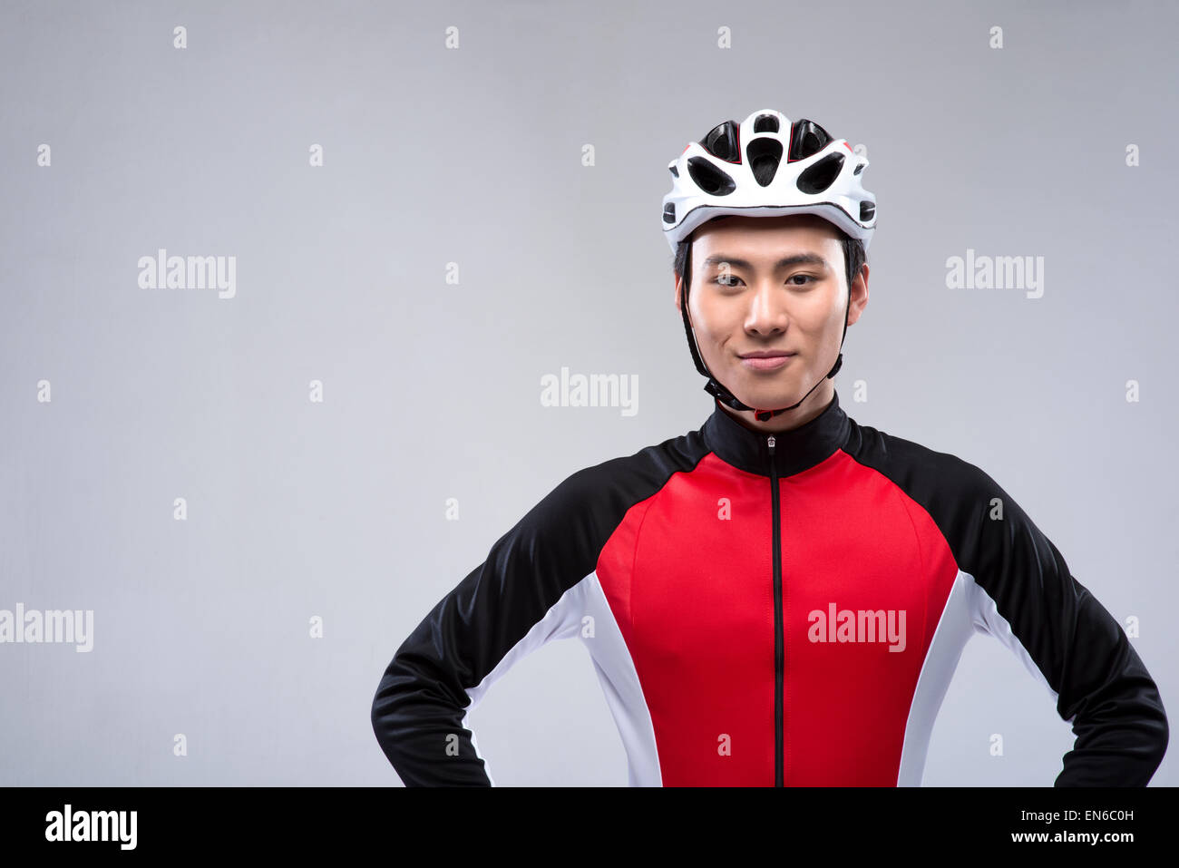 Young man standing with hands on hips before mountain biking Stock Photo