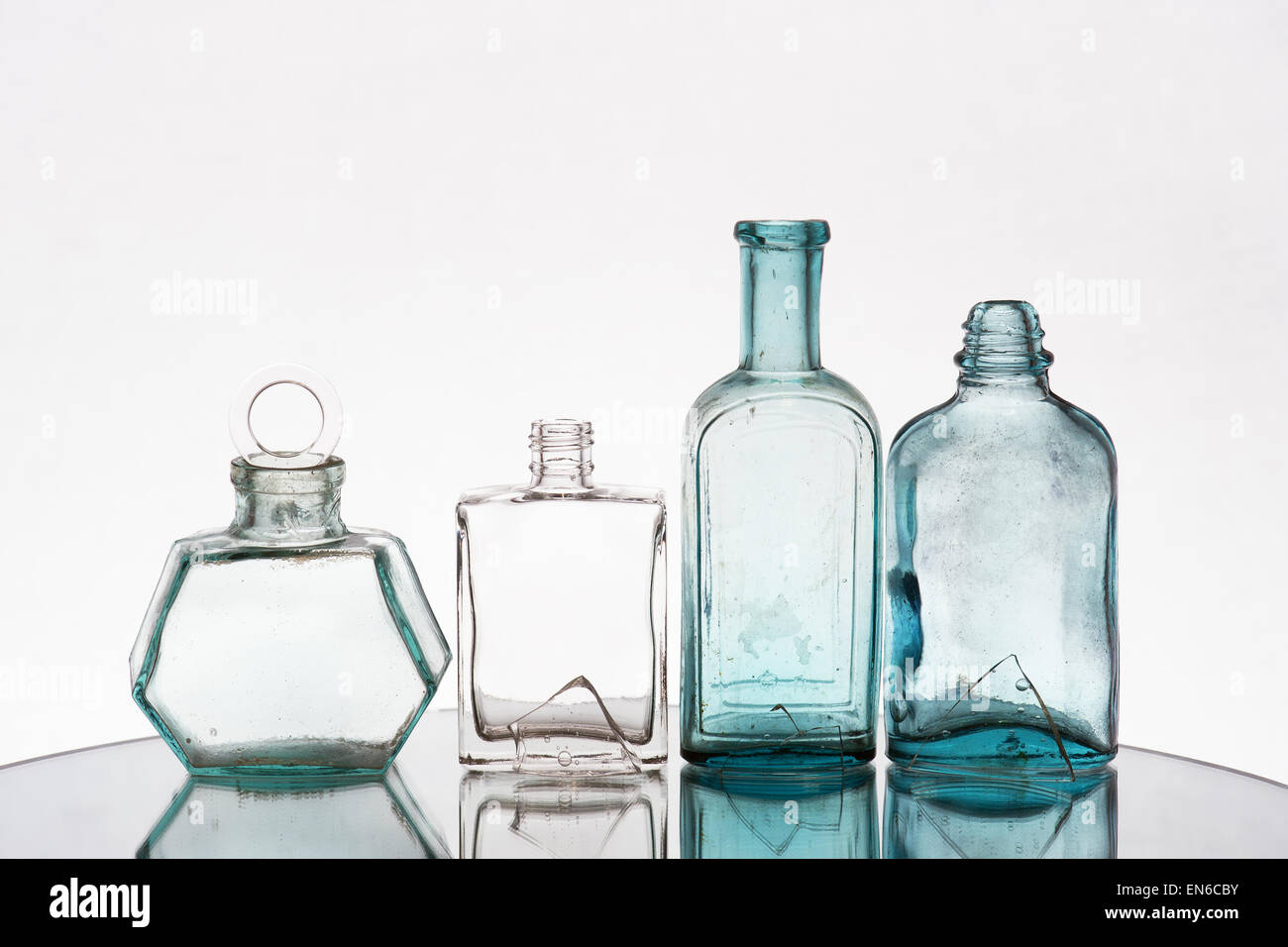 Composition of various vintage bottles and shards of glass on the light background Stock Photo