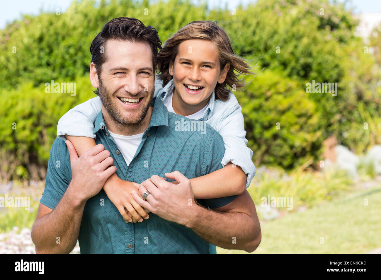 Father and son smiling at camera Stock Photo - Alamy
