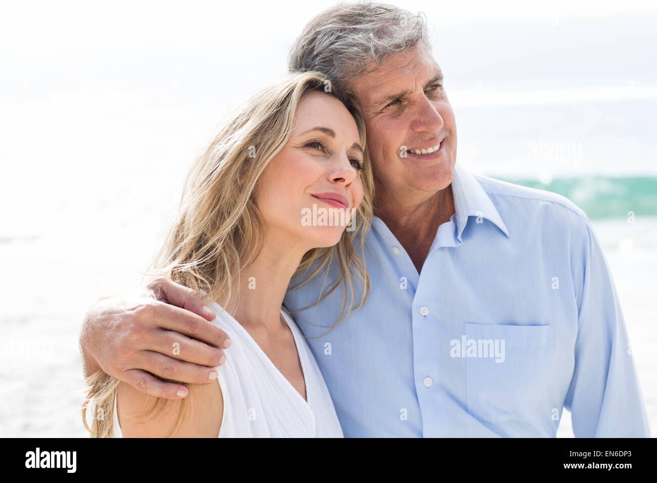 Happy couple standing by the sea Stock Photo - Alamy