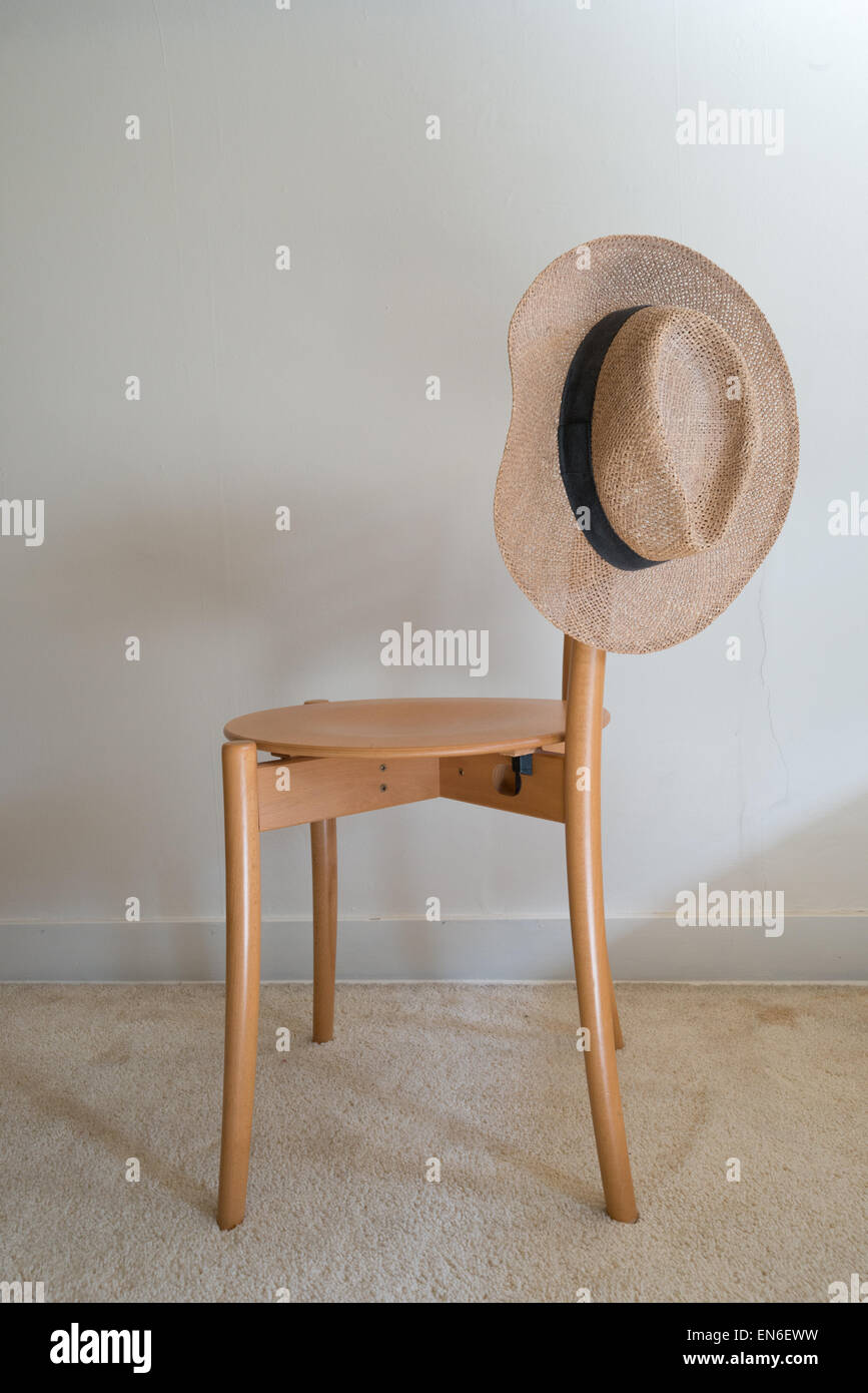 Men's straw fedora hat on chair Stock Photo