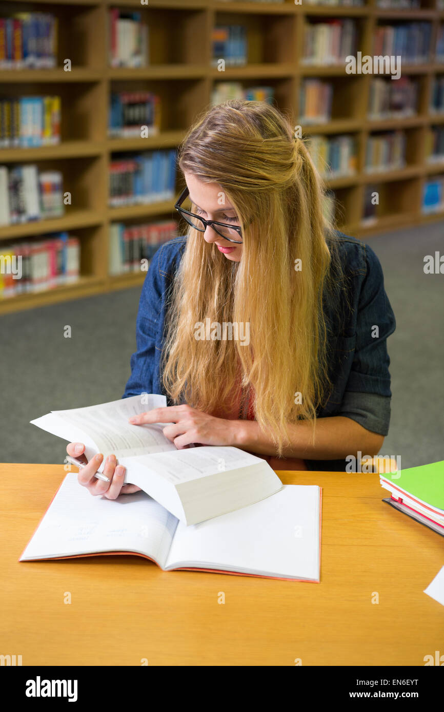 Student studying in the library Stock Photo - Alamy
