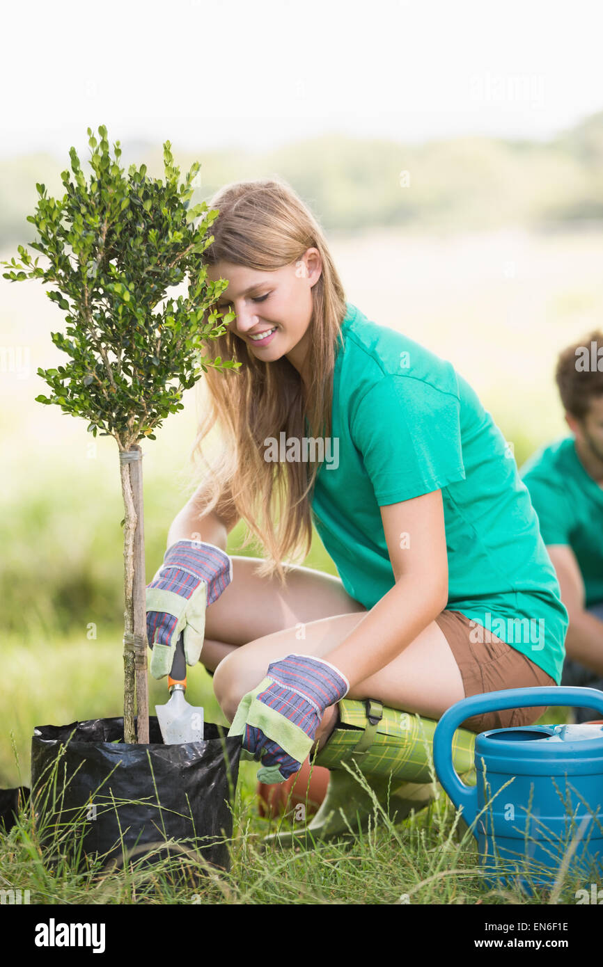 Pretty blonde gardening for her community Stock Photo