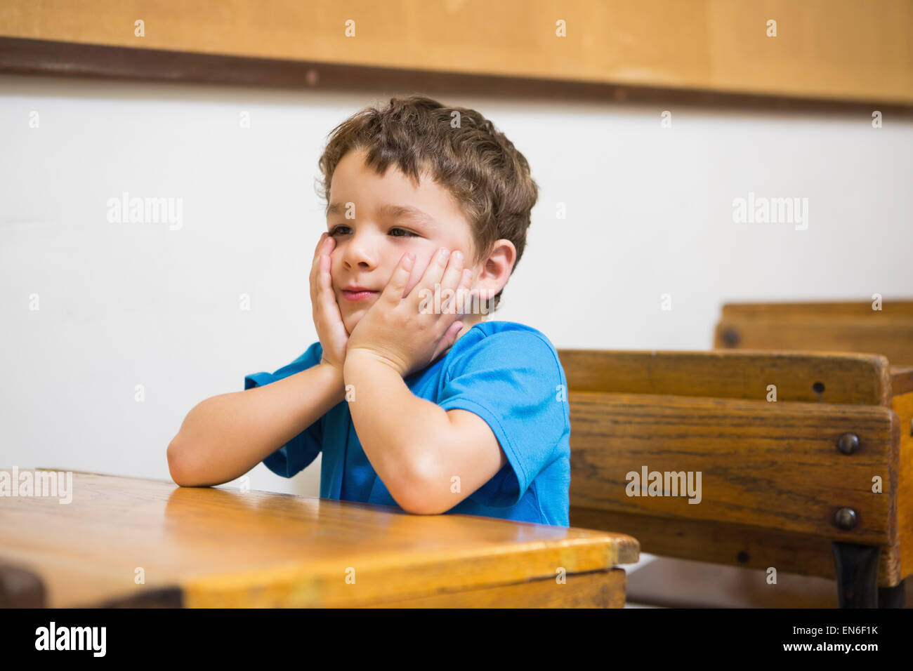 Focus pupil sitting at his desk Stock Photo - Alamy