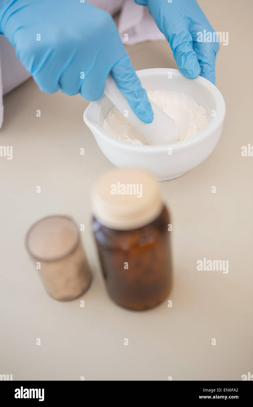 Scientist using pestle and mortar Stock Photo Alamy