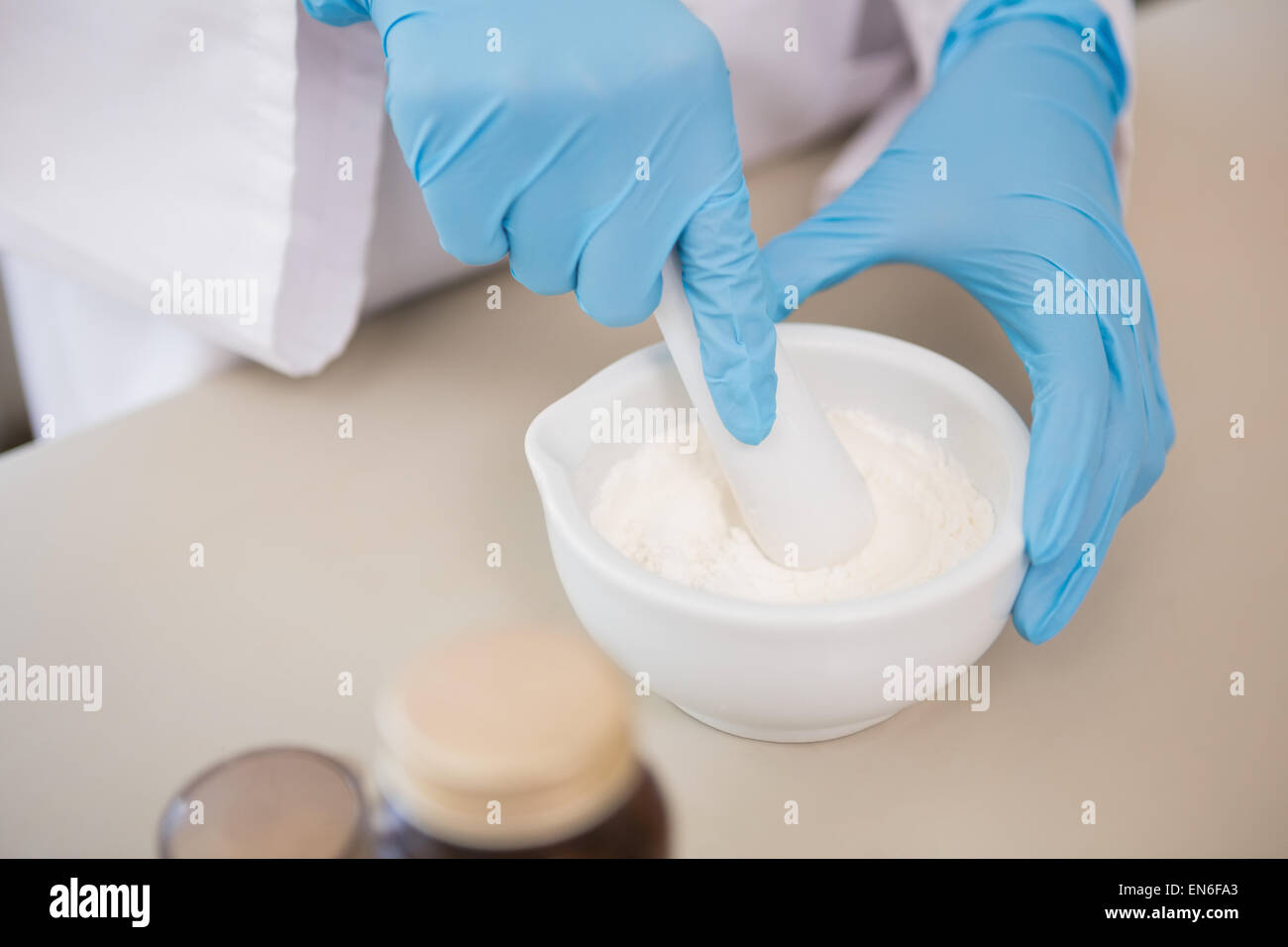 Scientist using pestle and mortar Stock Photo Alamy