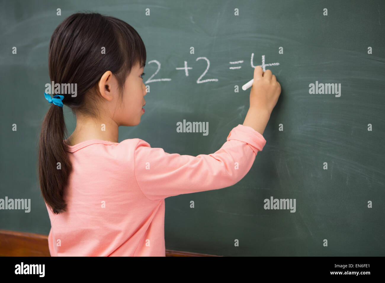 Pupil writing numbers on a blackboard Stock Photo
