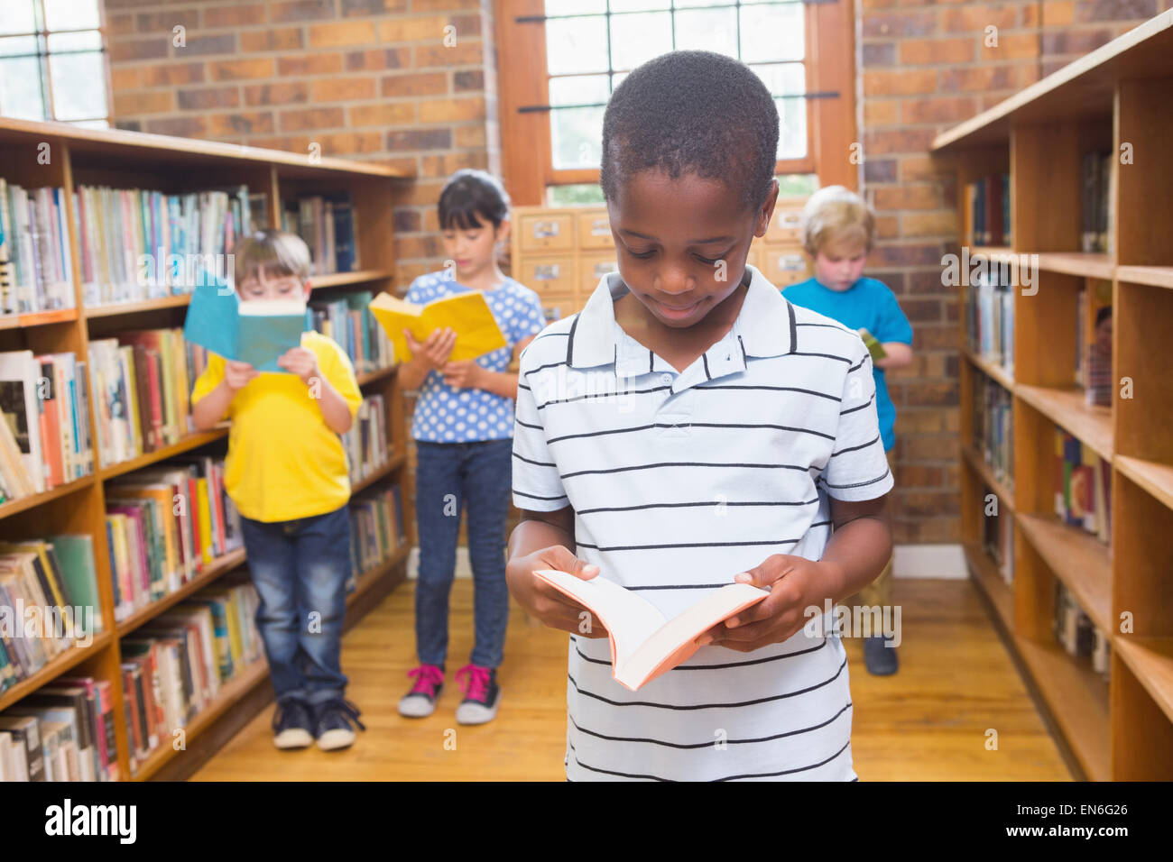 Pupils looking for books in library Stock Photo - Alamy