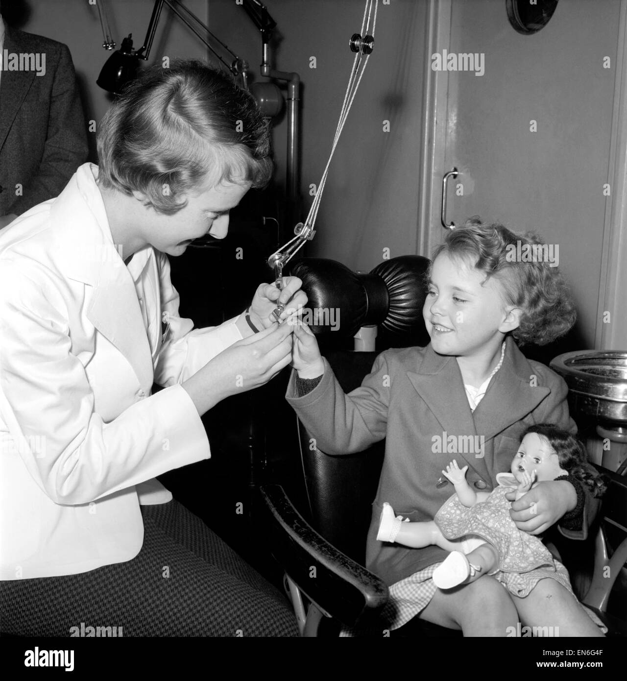 Girl in the Dentist's Chair at a Dental Clinic for children. 1954. Stock Photo