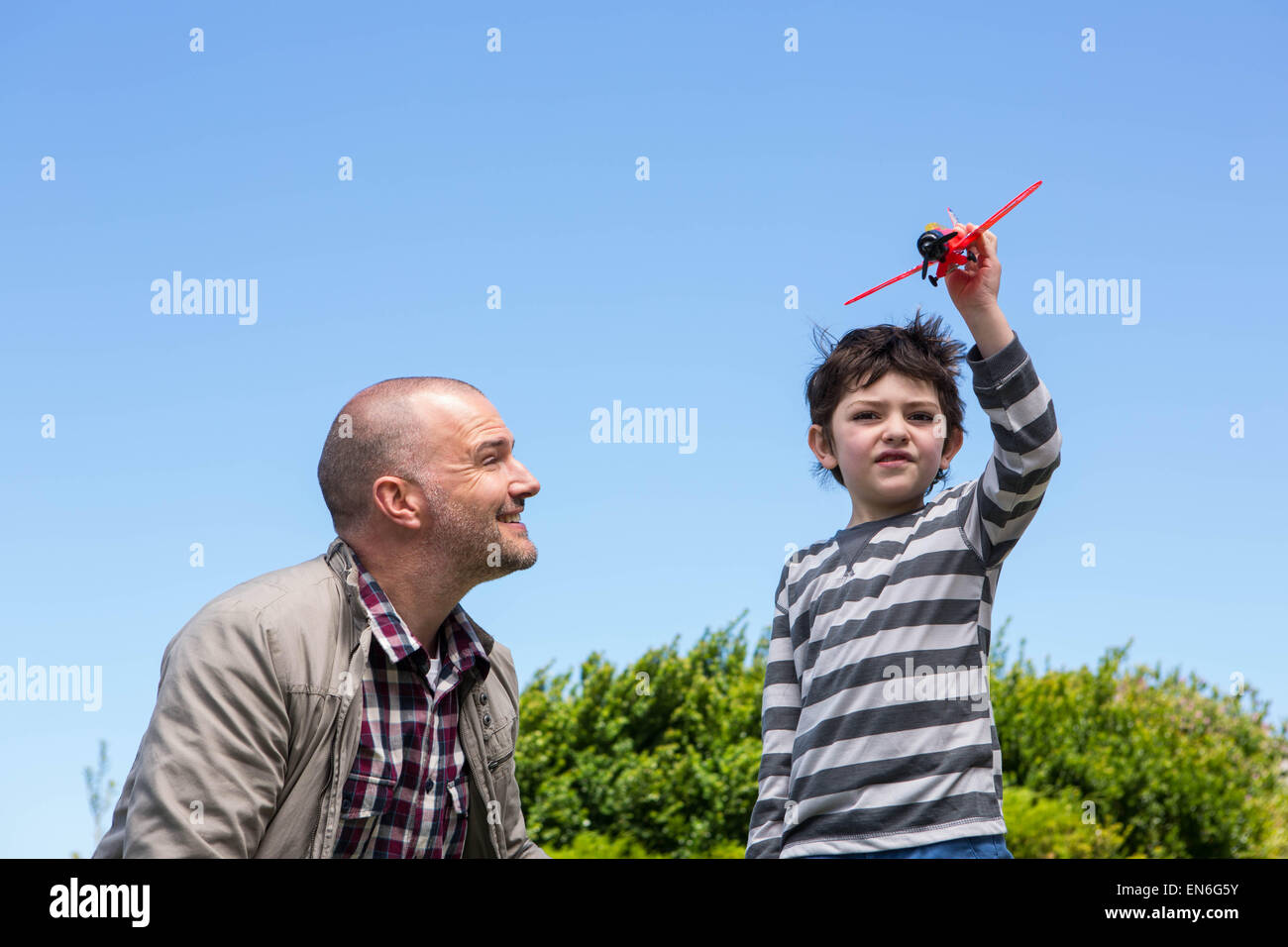 Young boy playing with a toy plane Stock Photo - Alamy