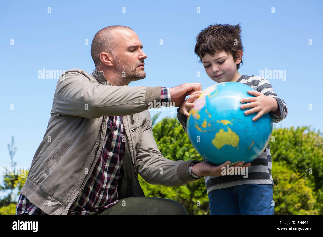 Father and son hiking in forest. Looking at map Stock Photo - Alamy