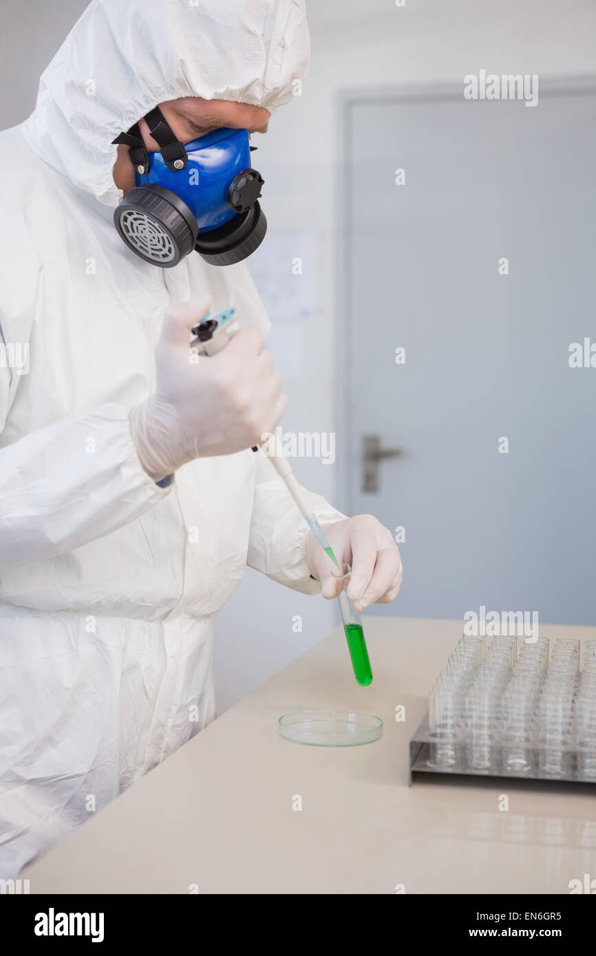 Scientist in protective suit doing experimentations Stock Photo