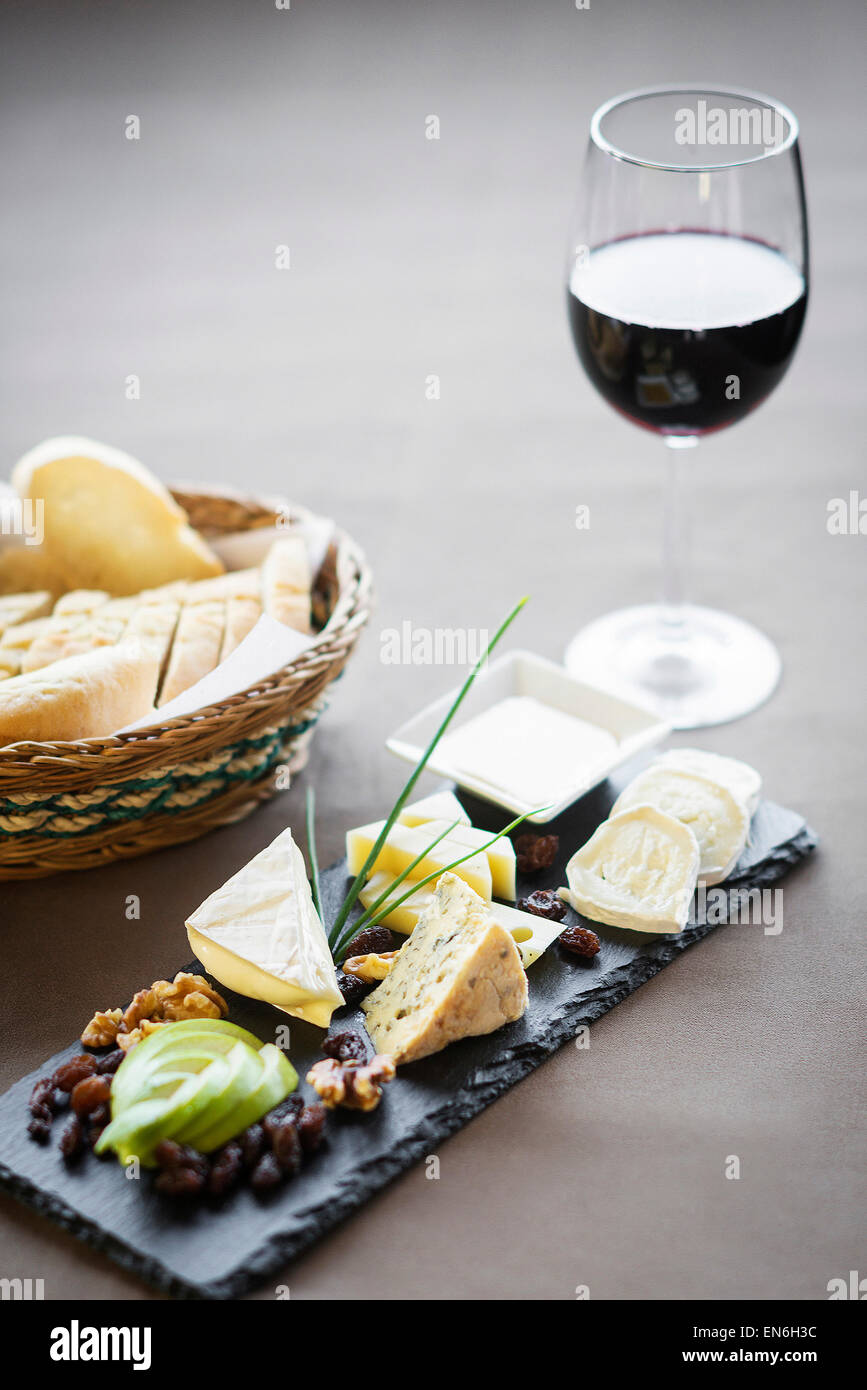 mixed french cheese platter with red wine glass and bread Stock Photo