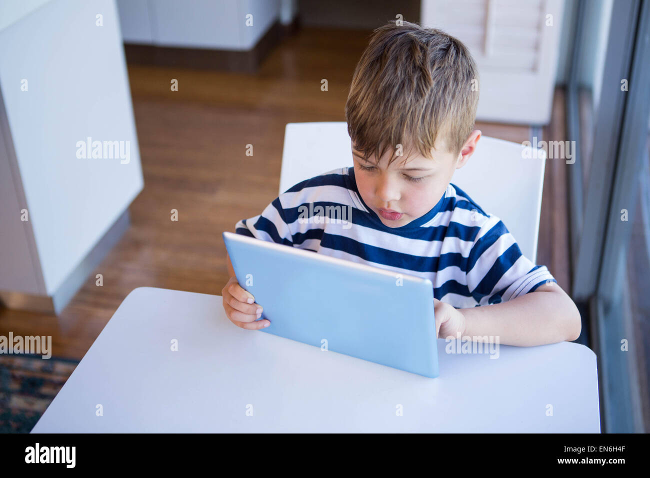 Little boy using tablet pc Stock Photo - Alamy