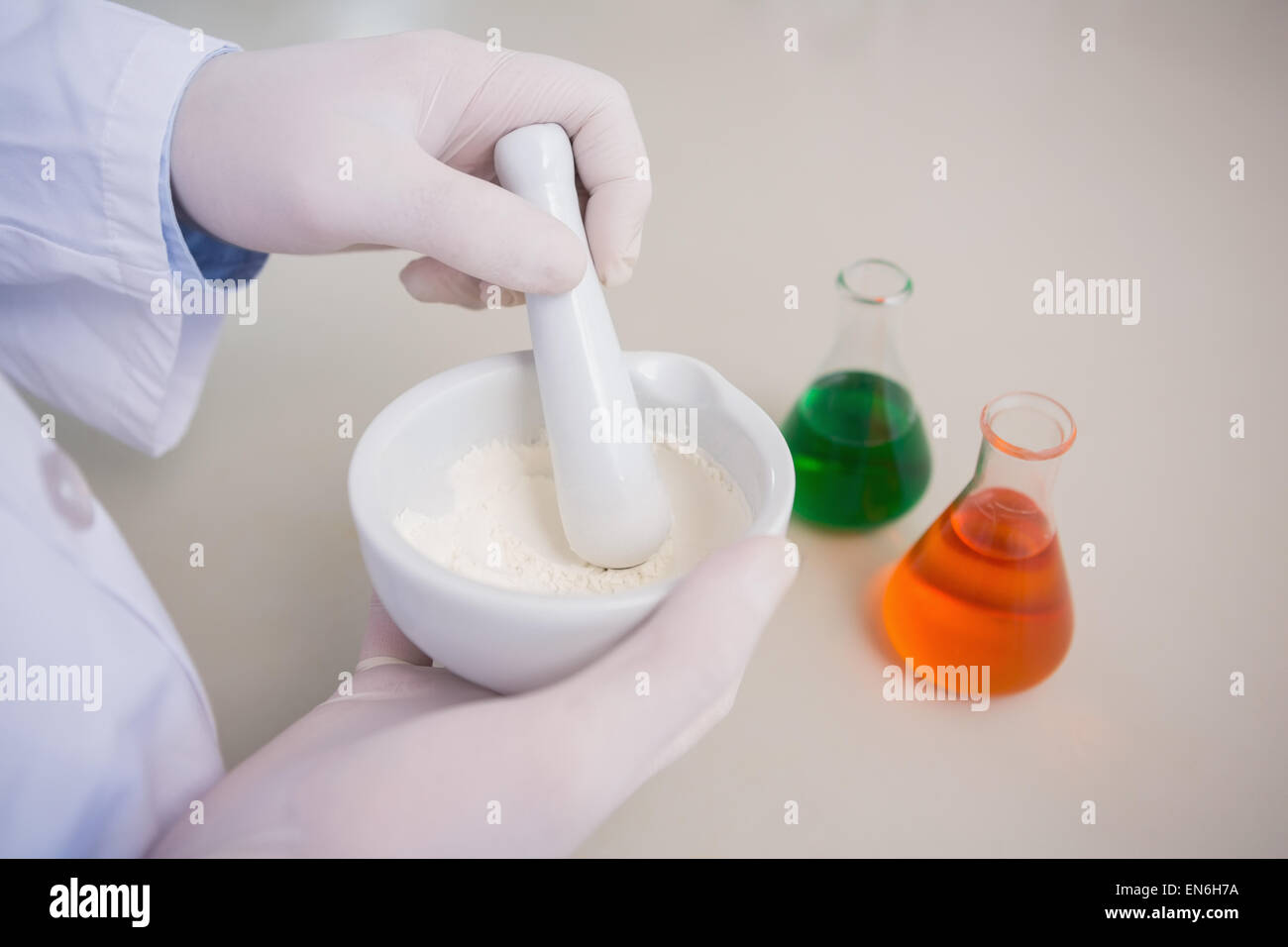 Scientist grinding powder with mortar Stock Photo Alamy