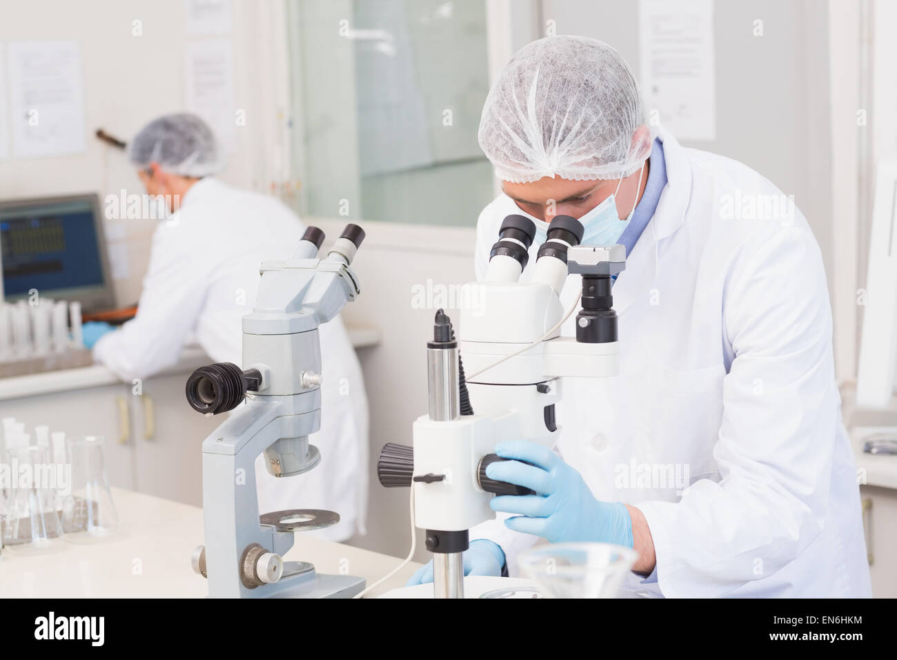 Scientists working attentively with microscopes Stock Photo
