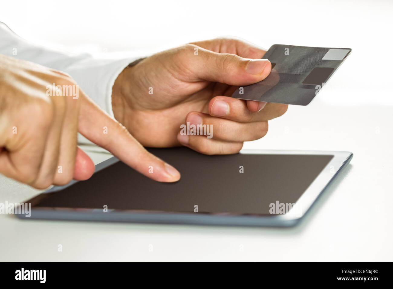 Man using tablet for online shopping Stock Photo - Alamy