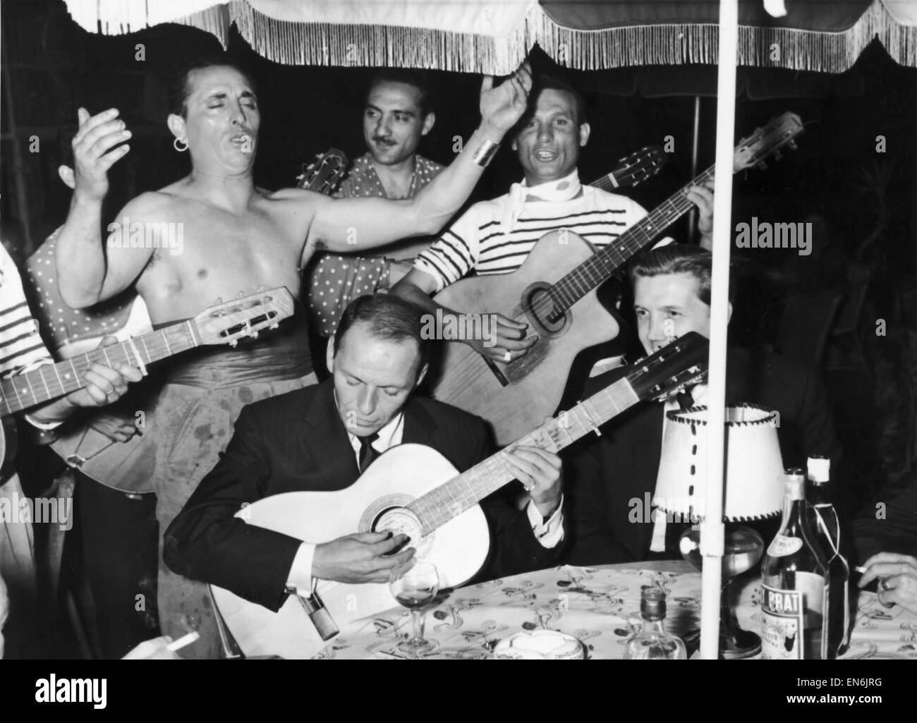 Frank Sinatra seen here playing the guitar during a gala party held by Grace Kelly in Monte Carlo. 16th June 1958 Stock Photo
