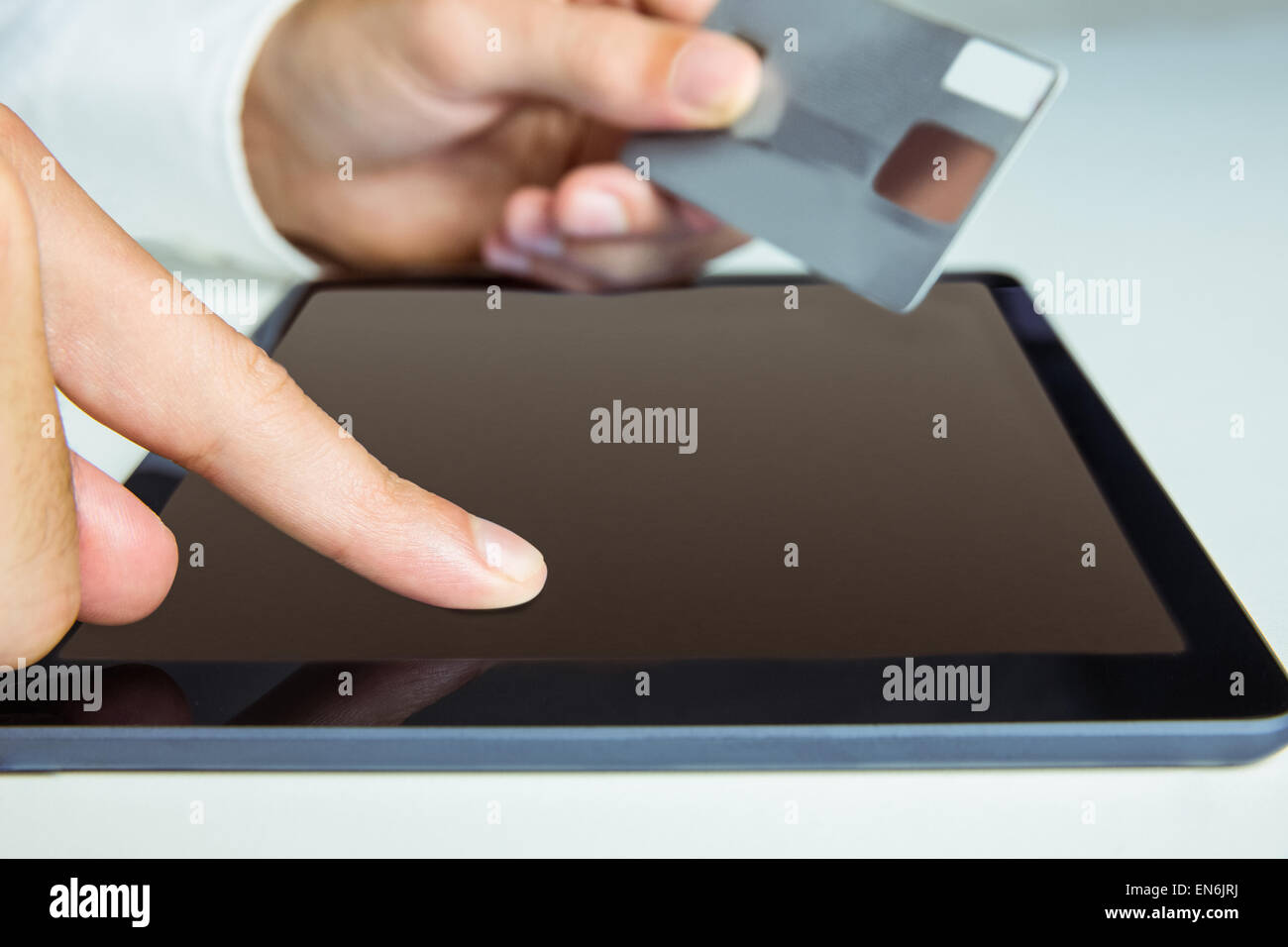 Man using tablet for online shopping Stock Photo - Alamy