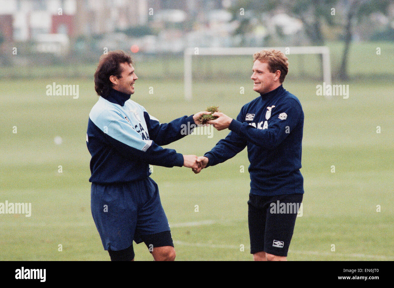 Lazio footballer Paul Gascoigne is handed a piece of turf by teammate Roberto Cravero during a team training session. 19th October 1992. Stock Photo