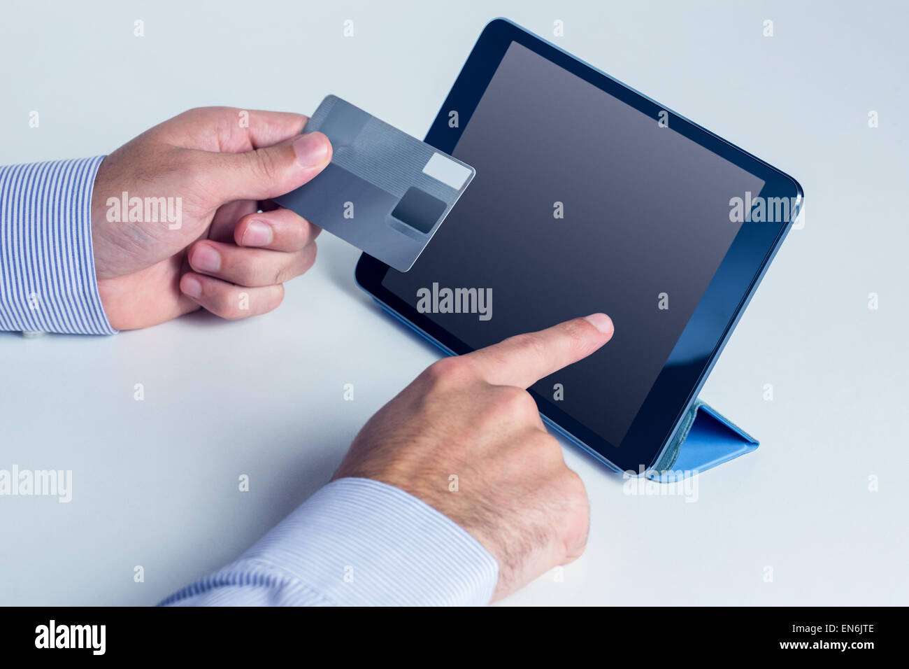 Man using tablet for online shopping Stock Photo - Alamy