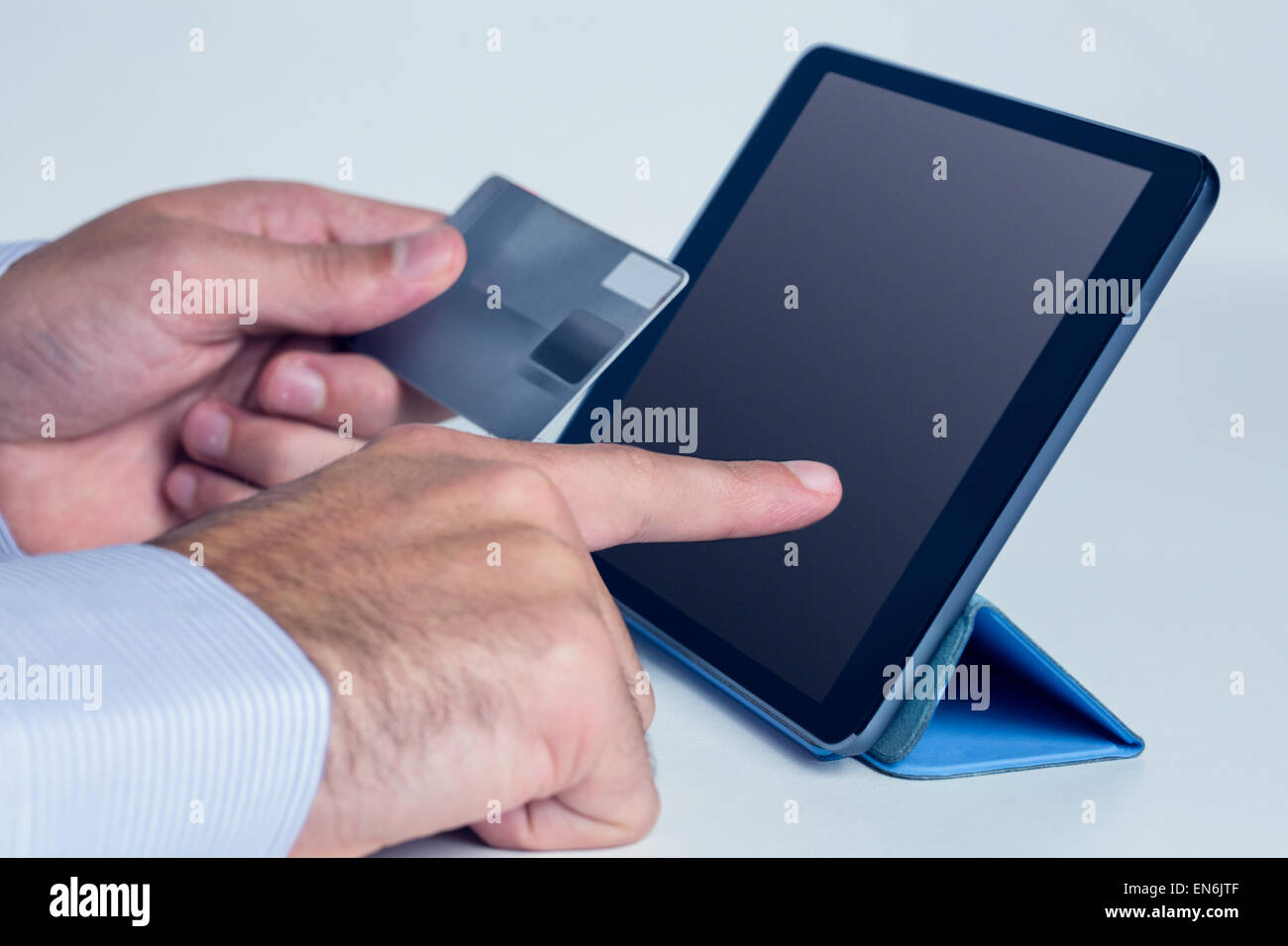 Man using tablet for online shopping Stock Photo - Alamy