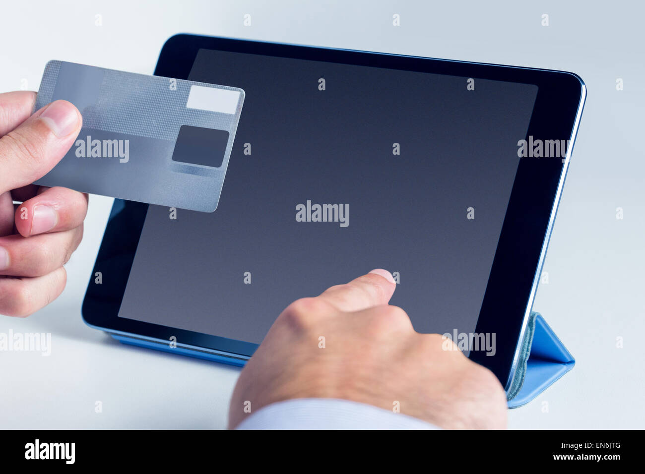 Man using tablet for online shopping Stock Photo - Alamy