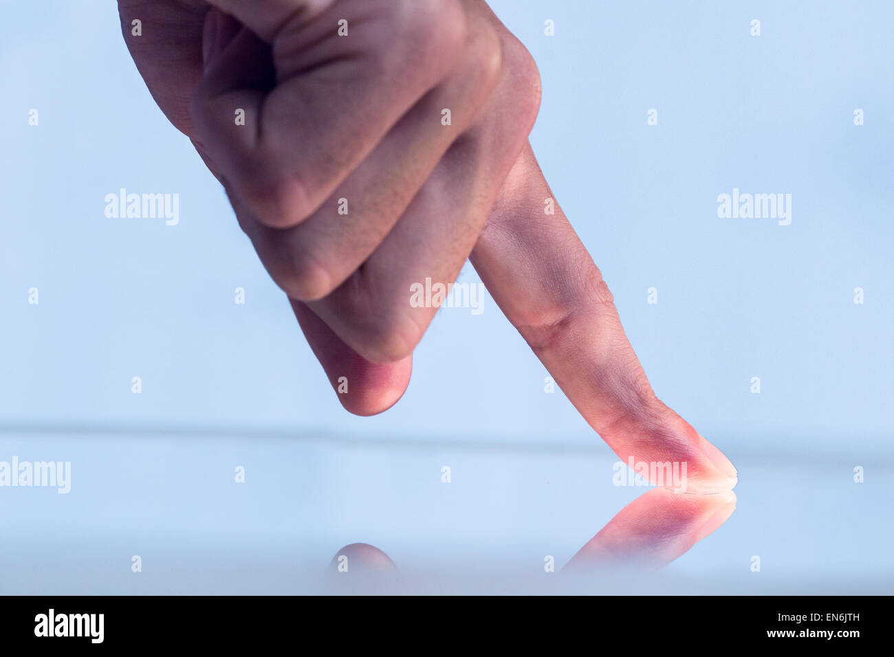 Man pointing on reflective surface Stock Photo