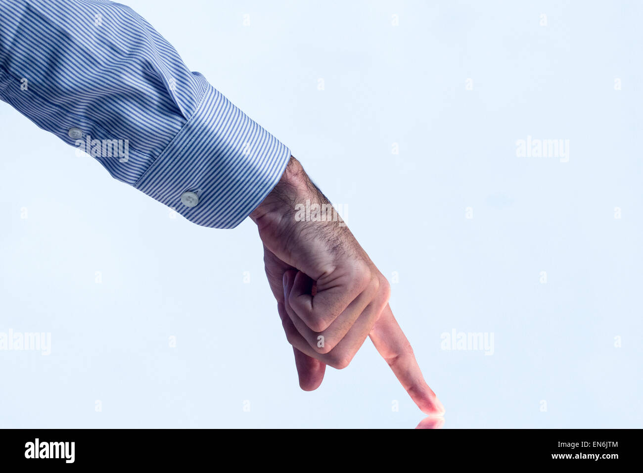 Man pointing on reflective surface Stock Photo