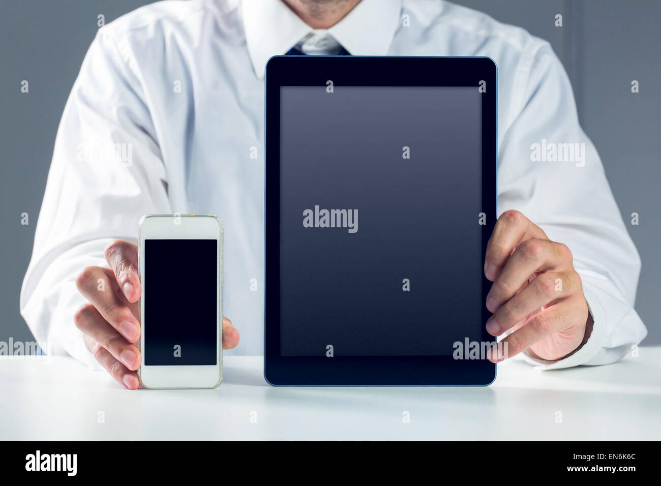 Businessman showing smartphone and tablet Stock Photo