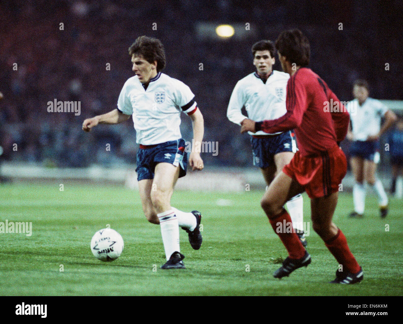 1990 World Cup Qualifier at Wembley Stadium. England 5 v Albania 0. England's Peter Beardsley on the ball faced by an Albanian defender as Neil Webb looks on. 26th April 1989. Stock Photo