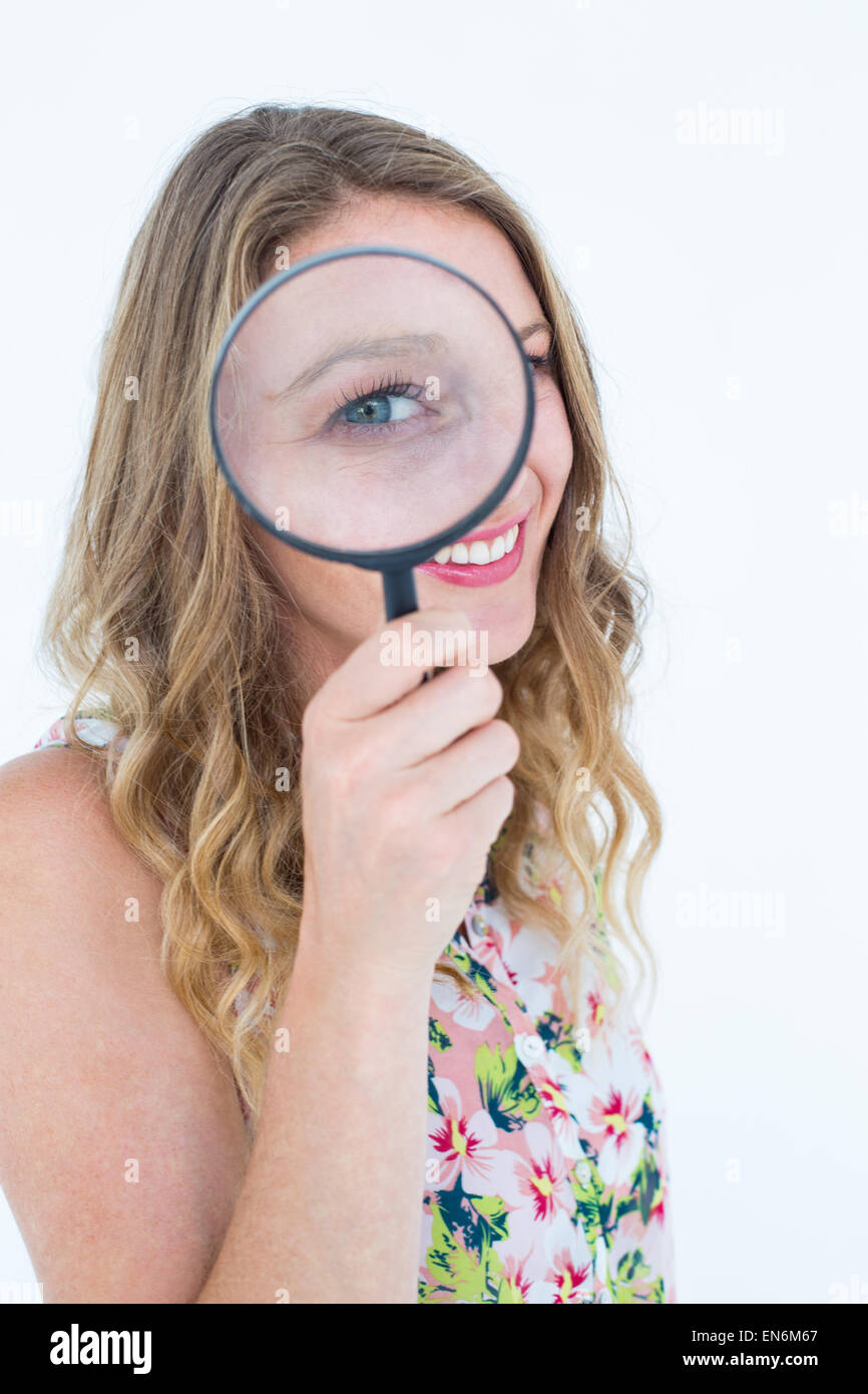 Smiling woman holding magnifying glass Stock Photo - Alamy