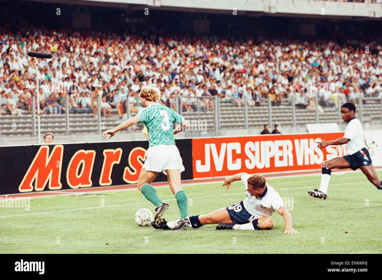 1990 World Cup Semi Final match the Stadio delle Alpi in Turin, Italy. West Germany 1 v England 1 (West Germany won on penalties). England's Paul Gascoigne challenges Andreas Brehme for the ball as Paul Parker moves in during the match. 4th July 1990. Stock Photo