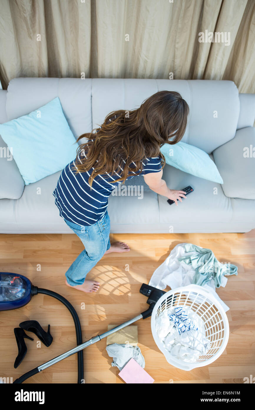 Pretty brunette cleaning the living room Stock Photo