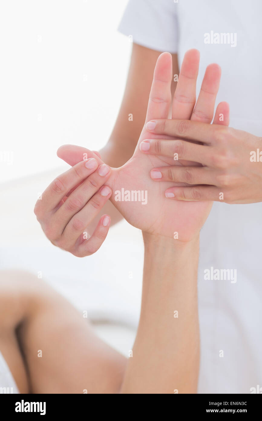 Physiotherapist doing hand massage Stock Photo
