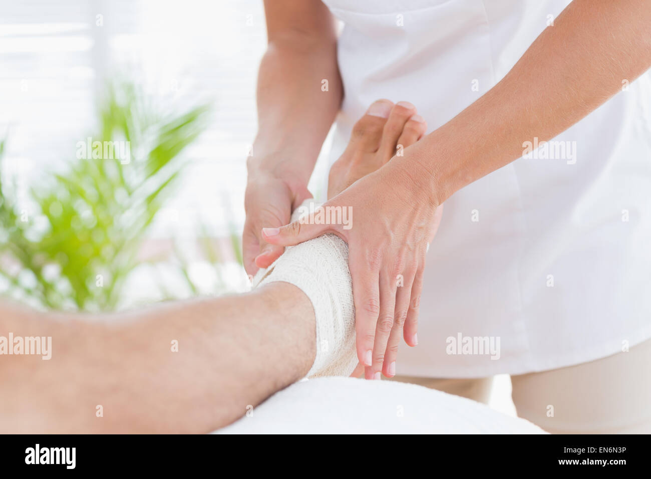 Doctor examining her patient ankle Stock Photo