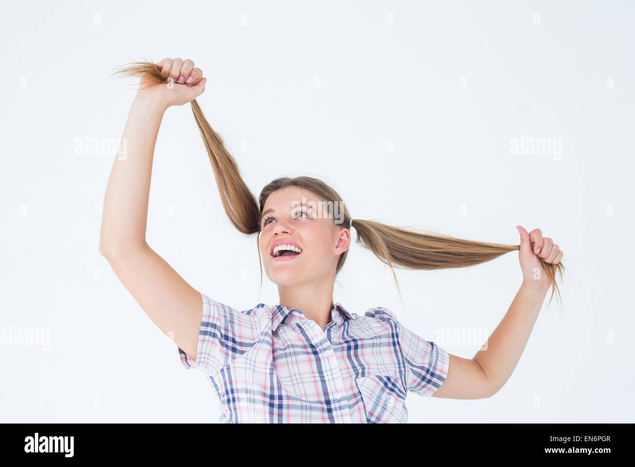 Geeky hipster holding her pigtails Stock Photo