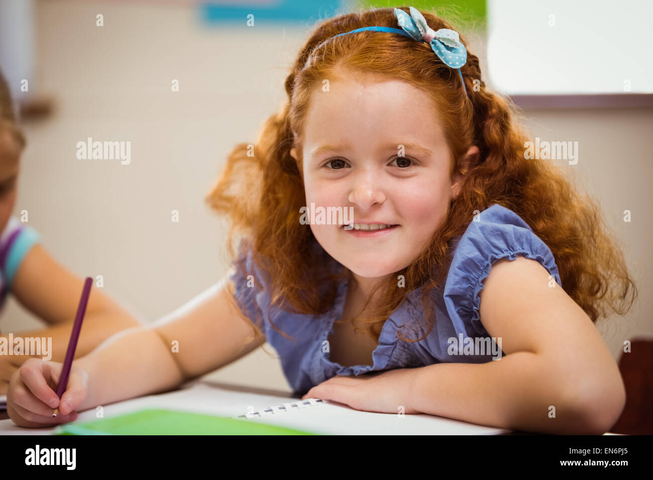 Pupil working hard at desk Stock Photo