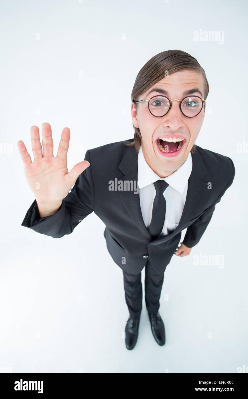 Geeky businessman waving at camera Stock Photo