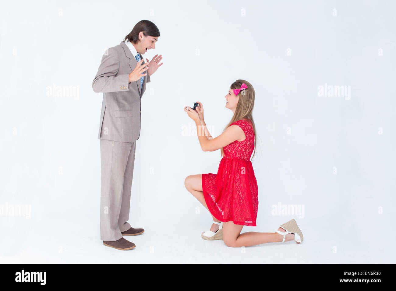 Pretty hipster on bended knee doing a marriage proposal to her boyfriend Stock Photo