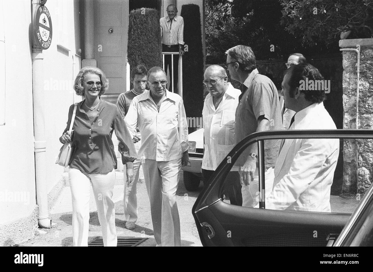 Frank Sinatra and wife Barbara seen here leaving David Nivens house in the South of France, following lunch with Nivens celebrity friends and the Monaco royal family. Actor Gregory Peck waits for the couple beside the car. 20th July 1978 Stock Photo